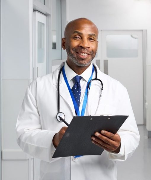 Portrait,Of,Smiling,Mature,Doctor,Wearing,White,Coat,In,Hospital